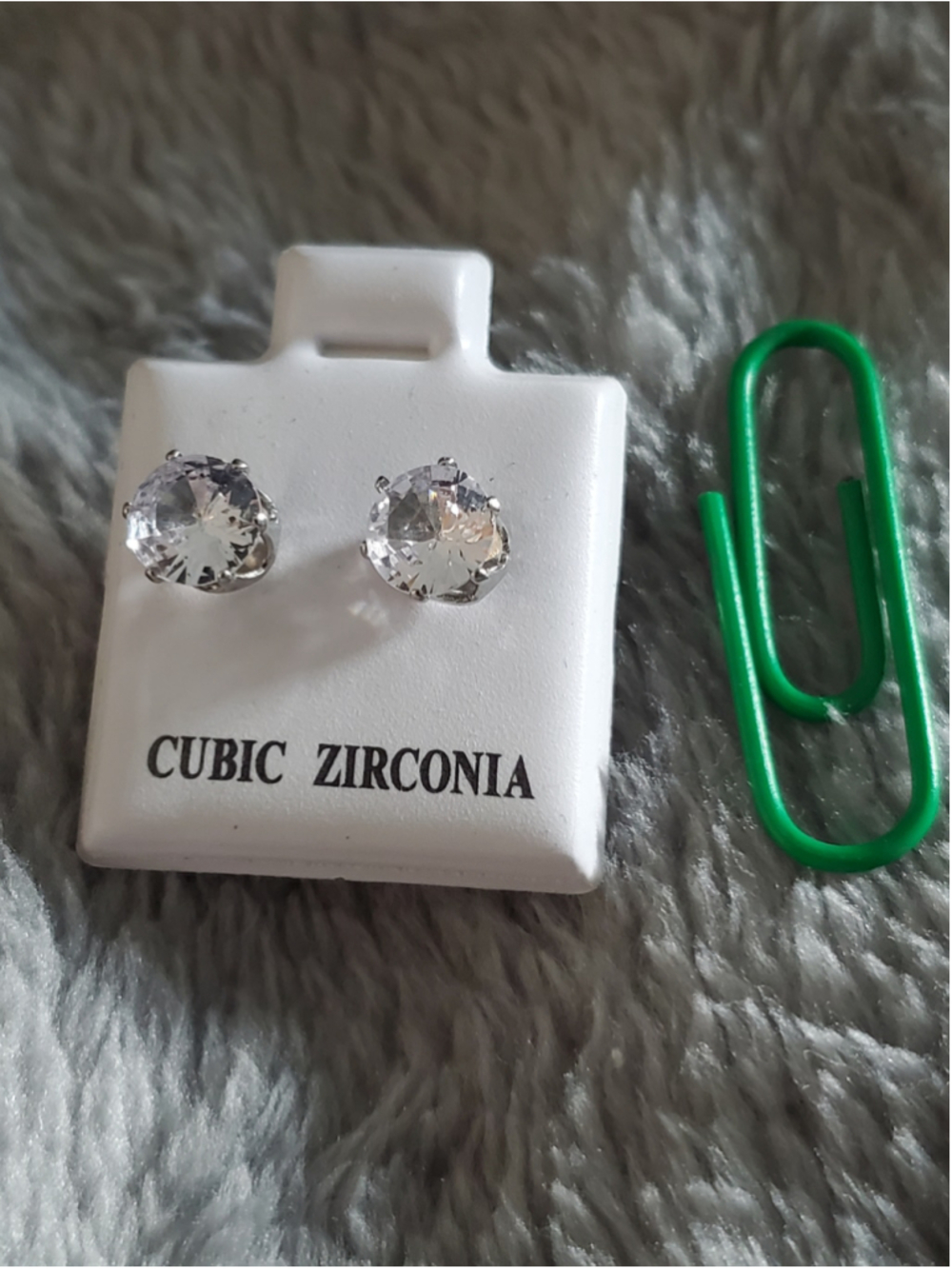Stud earrings #3 feature clear, round-cut cubic zirconia stones set in a silver-